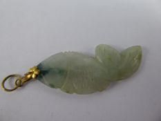 An Antique Chinese White and Green Jade Hand Carved Pendant, depicting a fish, approx 4.5 cms with