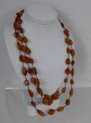 A Lady's Three Strand Amber Bead Necklace, approx 30 cms