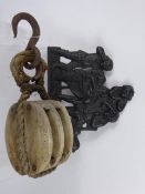 An Antique Ships Pulley Hoist, together with a cast iron door plate, depicting a tavern scene.