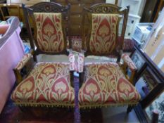 A Pair of Edwardian Oak Framed Arm Chairs, upholstered in the Art Nouveau style.