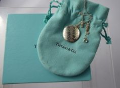 A Lady's Silver Tiffany & Co Pendant and Chain, in the original pouch and box.