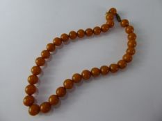 A Set of Antique Butterscotch Polished Amber Beads, approx 1 cm round, approx 38 cms long, approx wt