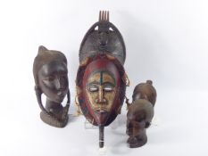 Four African Tribal Figures, including a painted Sub-Saharan mask, together with three hard wood