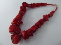 An Antique Raw Coral Necklace, the coral crafted from gradual 'bone form' segments, largest