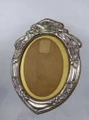 A Silver Art Nouveau Oval Picture Frame, with an oak easel back, Birmingham hallmark, dated 1904,