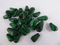 A Collection of Malachite Hand Carved Beads, approx 25, from approx 2 to 3 cms in length.