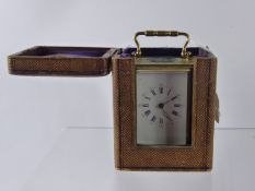 A French Brass Carriage Clock, movement stamped SFRA, white enamel face, Roman dial, in the original