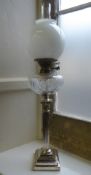 A Regency Style Corinthian Oil Lamp, the lamp having a cut-glass reservoir, approx 79 cms high.