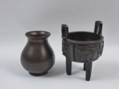 A Chinese Bronze Censer, in the 17th century style, decorated with Taotie mask raised on tripod