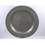 An English Pewter Plain Rim Charger, circa 1730, ownership initial and feint marks to verso,