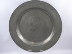 An English Pewter Plain Rim Charger, circa 1730, ownership initial and feint marks to verso,