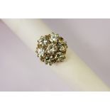 A Lady's 18 ct Yellow and White Gold Brilliant Cut Diamond Daisy Cluster Ring, the ring set with