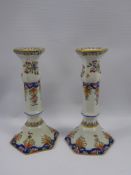 A Pair of Faience Candlesticks, hand painted with flowers, approx 22 cms, painted to base JJ nr