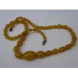 A Lady's Antique Amber Coloured Necklace, approx 23 x 18 mm, approx 28 cms.