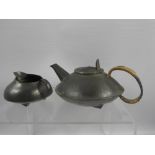 A Hammered Pewter Creamer and Tea Pot, the teapot stamped 0231 to base and English pewter made by