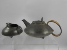 A Hammered Pewter Creamer and Tea Pot, the teapot stamped 0231 to base and English pewter made by