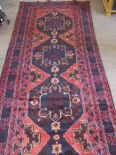 An Afghan Baluch Long Rug or Runner, with fine central blue and pink cartouche and geometric