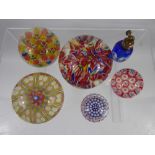 Three Vintage Multi Coloured Cane Paperweights, together with two miniature paperweights and a glass