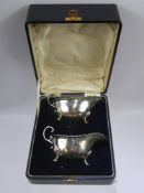 A Pair of Solid Silver Sauce Boats, the sauce boats having scalloped edge on hoof feet, Birmingham