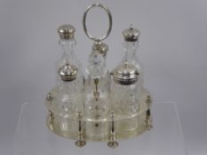 Two Silver Plated Cut Glass Cruet Sets and Stands, one with some silver tops. (2)