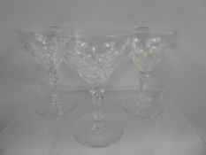 A Set of Thirteen Vintage Cut Glass Champagne Glasses, the cup-form glasses having a stepped bowl