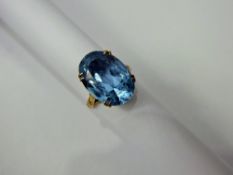 A Lady's 9 ct Gold Blue Topaz Ring, topaz 18 x 14 mm in basket setting, size M, approx 5.3 gms.
