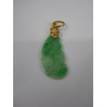 A Chinese Apple Green Jade Pendant, in the form of a bat, on a 14 ct gold loop, approx 2.7 cms,
