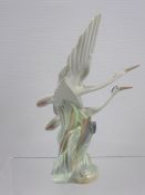A 20th Century Lladro (Nao) Model Group of a Pair of Herons in Foliage, decorated in typical subdued