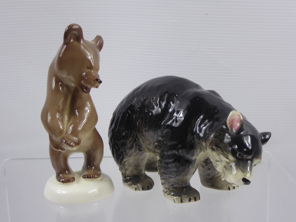A Pair of Japanese Porcelain Black Bear Figurines, together with a Russian made brown bear figurine.