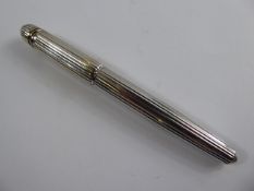 A Pasha de Cartier Silver Plated Ink Pen, the ink pen having silver and gold decorations to lid
