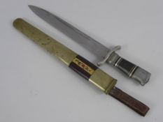 A Vintage Middle Eastern Dagger, the dagger has a 23 cms fullered blade and measures 32 cms overall.