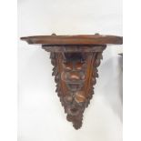 An Antique Carved Oak Wall Bracket, depicting a lion's head and foliage, approx 48 x 31 x 23 cms