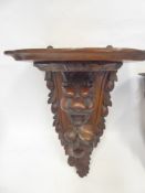 An Antique Carved Oak Wall Bracket, depicting a lion's head and foliage, approx 48 x 31 x 23 cms