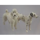 A Beswick Figure of a Dalmatian, together with a porcelain figure of a French poodle. (2)