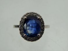 An 18 ct White Gold Sapphire and Diamond Ring, the central oval sapphire approx 9.6 x 7.7 mm, 3.35