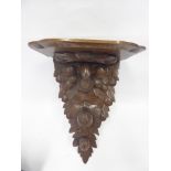 An Antique Oak Carved Wall Bracket, the bracket depicting carved acorns, approx 41 x 30 x 22 cms.