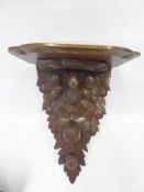 An Antique Oak Carved Wall Bracket, the bracket depicting carved acorns, approx 41 x 30 x 22 cms.