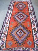 A Large Kilim Rug, blue and red design, approx 295 x 127 cms.