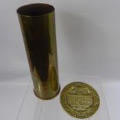 A WW1 Brass Shell Casing, together with a WW2 brass plaque commemorating 'Reims Capitulation of