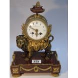 GRIGNON MEUSNIER CLOCK WITH A BRASS LION MOUNTED ON A RED MARBLE BASE. MARKED BREVETE TO INSIDE