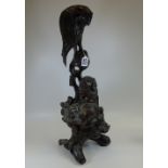 TALL CARVED ORIENTAL WOODEN FIGURE OF AN EAGLE OVER LOOKING A DOG OF FO