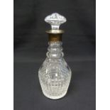 Cut glass decanter with drop stopper and silver collar