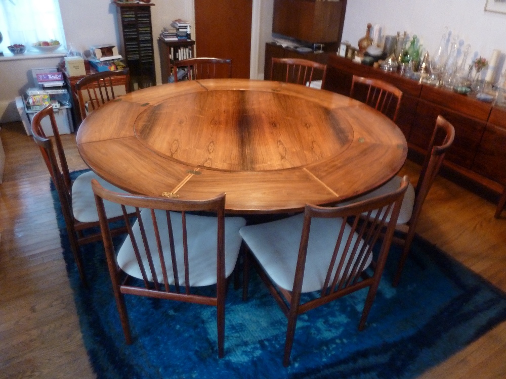 A 1970s Dyrlund of Denmark Rosewood circular dining table and eight matching spindle back chairs (