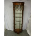 An early 20th century mahogany bow fronted display cabinet with five shelves on four bracket feet