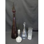 A quantity of glass to include an amethyst coloured bottle and stopper and three other glass pieces