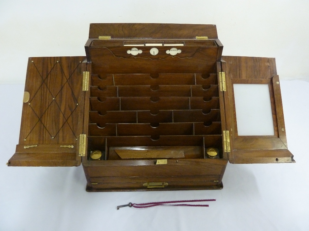 A Victorian walnut fitted stationery box with hinged doors and single drawer with brass handle