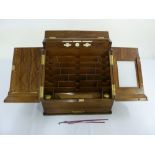 A Victorian walnut fitted stationery box with hinged doors and single drawer with brass handle