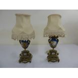 A pair of French gilt metal and porcelain garnitures, converted into table lamps