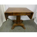 Drop flap library table on pedestal base with four carved claw feet