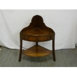 A Victorian mahogany two tier corner whatnot with three drawers on three sabre legs